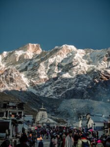 Crowd at Kedarnath Temple, India with stunning Himalayan backdrop, a top travel destination.