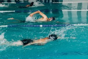 Energetic shot of swimmers practicing freestyle in a pool.