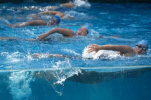 Energetic swimmers race through the pool, showcasing dynamic athleticism and competitive spirit.