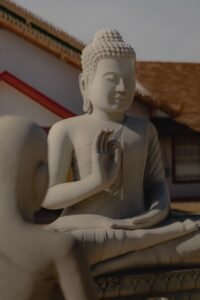 A tranquil outdoor stone Buddha sculpture conveying peace and spirituality.