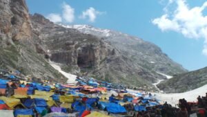 A colorful tent settlement amidst rugged mountainous terrain in Kashmir, India.