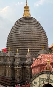 Explore the intricate architecture of Kamakhya Temple, a sacred site in Assam, India, with its iconic dome and ornate details.