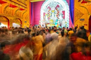 Blurred motion scene of devotees attending Durga Puja in Kolkata temple, India.