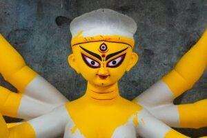 Intricate handcrafted clay idol depicting Goddess Durga in a Kolkata workshop, showcasing traditional Bengali artistry.