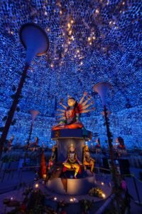 Intricate Durga Puja decorations in Kolkata, capturing vibrant blue lighting and traditional statues.