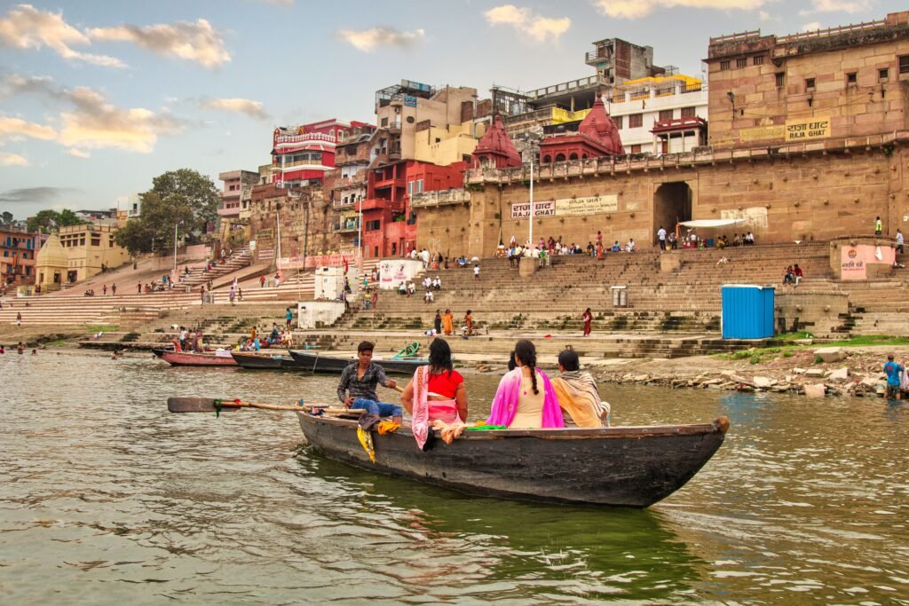 A serene boat ride along the Ganges River with a backdrop of Varanasi's historic ghats.