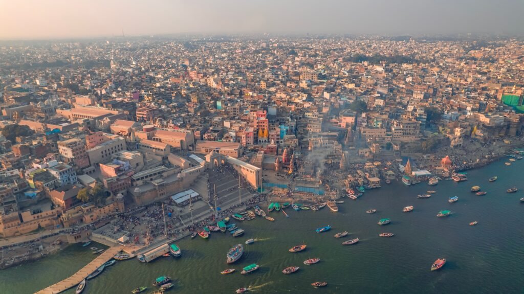Stunning aerial shot of Varanasi's Ghats along the Ganges River at dusk, showcasing cultural vibrancy.